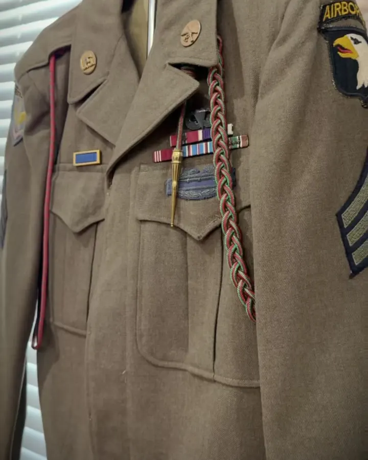 An Airborne sergeant's jacket with ribbons and a braided cord, from the museum's collection film.